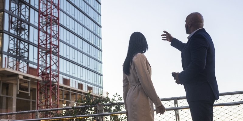 realtor looking at high rise with client